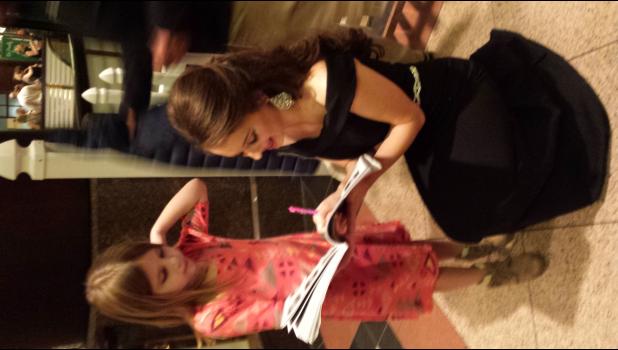 Clare signs an autograph for a young girl at the competition. Photo provided.
