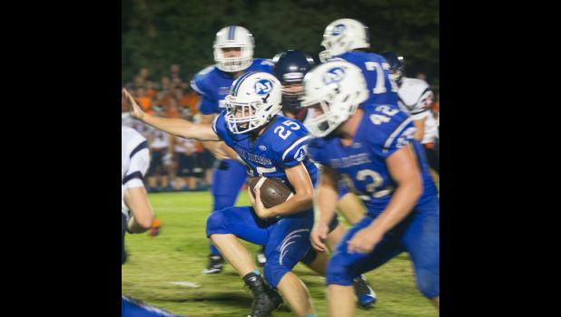 Anna-Jonesboro’s Kyle McMahan, number 25, looks for some running room. Also in the photo is teammate Jayce Turner, number 42.