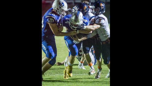 Anna-Jonesboro’s Bryce Osman, number 14, carried the ball, and some Carterville defenders, with him. Also in the photo is teammate Reid Morrison, number 28.