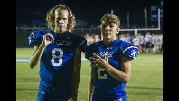 Wildcat teammates Jaryt Tripp, number 8, and Ross Pinnon, number 2, show that A-J had a 5-0 record following a homecoming game victory.
