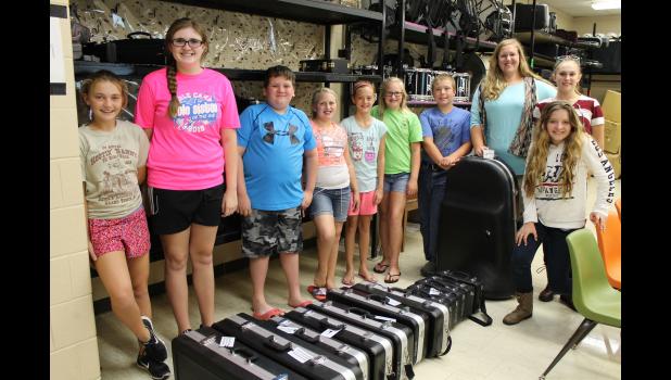 From left are Megan Theis, Alyssa Flores, Westin George, Kinley Lingle, Hailey Wright, Peyton Lingle, Noah Wiseman, Rebecca Gray, Michelle Wolford and Madison Boner with their new instruments. Photo by Lindsey Rae Vaughn.