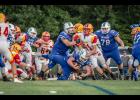 A-J’s Jayce Turner, number 42 in dark uniform, crosses the goal line to score a touchdown. Also in the picture are A-J players Noah Craig, number 70, Dylan Cunningham, number 72, and Carsten Christy, number 78.